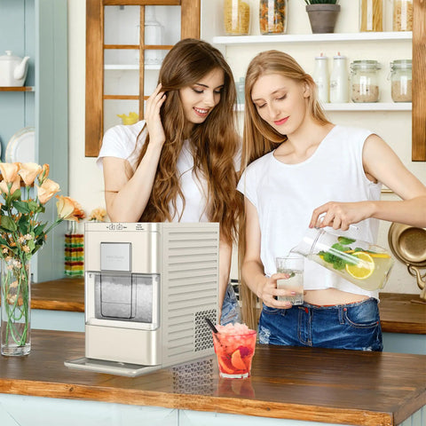Cream Countertop Nugget Ice Maker With Visible Window And Sleek Touchscreen pouring drinks in kitchen with friends.