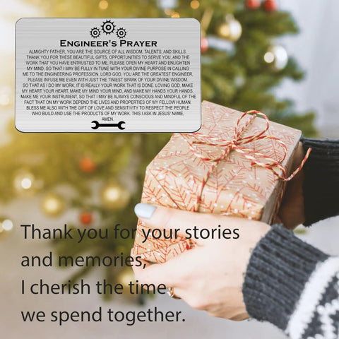 Woman holding a Christmas gift with a Techie Engineer Gift For Men Engineers Prayer Wallet Card Featuring Electrical And Mechanical Engineering Themed Jewelry For Engineers A Solid Fathers Day Retirement Gift For Dad Or Grandfather card nearby.