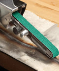 Cloth Grinding Belt 577F 3x132 In 80 YF-Weight, Alumina Zirconia Blend in use on metal surface, wet or dry use, heavy polyester backing.