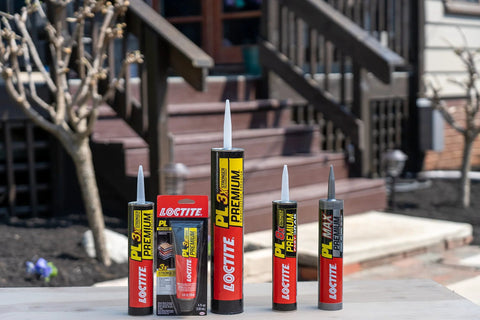 Front view of Loctite PL Premium polyurethane construction adhesive tubes, set of 5, on a wooden outdoor table