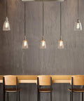 Three Light Industrial Pendant Lighting for Kitchen Island with Oval Clear Glass Shades, Brushed Steel Ceiling Fixture, Retro Modern Vibe Chandelier for Dining Room, Bar, Cafe and Office over wooden countertop