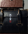 Eight Piece Adjustable Iron Toggle Latch Clamps With Quick Release installed on leather bag