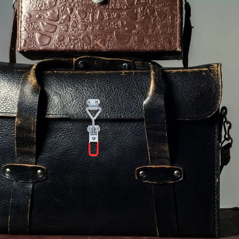 Close-up of Beefy 8 Pack Adjustable Toggle Latch Clamps With Quick Release on a leather bag, highlighting iron draw latch.