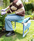 Person using Folding Garden Stool And Kneeler With Ten Point Two Inch Kneeling Pad Heavy Duty Garden Kneeler And Seat For Easy Gardening