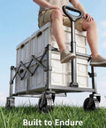Person sitting on a heavy duty folding wagon with wheels for groceries and outdoor use, demonstrating 250 lb capacity.