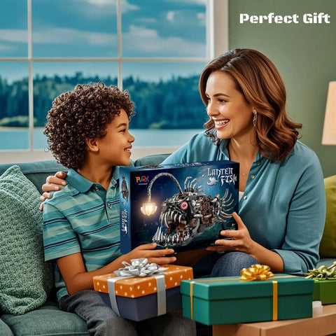 Mother and child smiling with Angler Fish Mechanical Building Block Set With Lights Dope STEM Toy For Kids And Adults box on sofa.