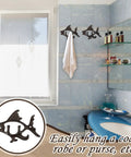 Dead Reliable Cast Iron Fish Wall Hooks 2 Pack mounted in bathroom with towel, showcasing nautical design and practicality.