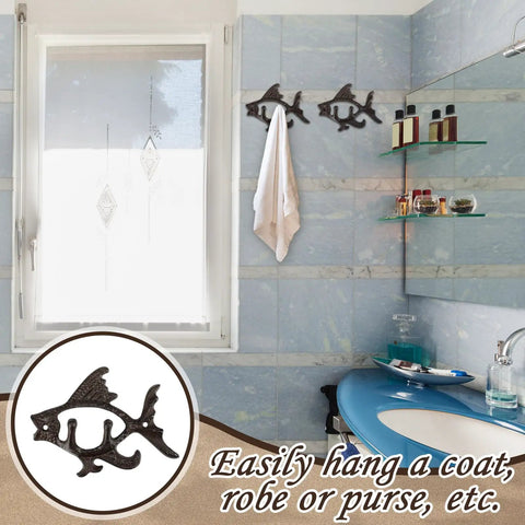 Dead Reliable Cast Iron Fish Wall Hooks 2 Pack mounted in bathroom with towel, showcasing nautical design and practicality.