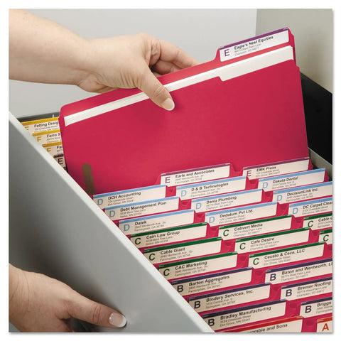 Hand holding letter size red fastener folder with assorted tabs in a filing drawer, ideal for hustle free filing.