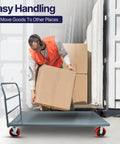 Man loading a box onto a Badass Heavy Duty Flatbed Platform Cart Designed To Crush Retail Loads Featuring A Solid Seventy Two By Thirty Six Inch Deck.