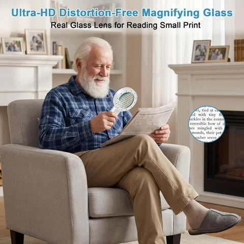 Senior man using Crystal Clear Lighted Handheld Magnifier With 12 LEDs for reading a newspaper in a cozy living room setting.