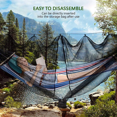 Person relaxing in a striped hammock protected by Camping Hammock Net With 360 Degree Mosquito Protection in a forest setting.