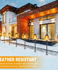 8 Pack Solar Tiki Torches With Realistic Flickering Flame lining modern home pathway in snow, showcasing weather resistance.
