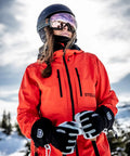 Person wearing Army Leather Heli Ski Glove For Freeriders And Mountain Guides Durable Five Finger Snow Gear with ski poles