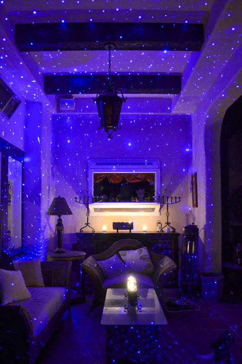Starport USB Laser Star Projector For Game Rooms And Bedrooms, blue stars projected in living room creating galaxy mood lighting