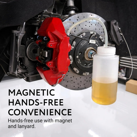 Installed Mission Automotive brake bleeder kit: white 16 oz magnetic bottle with tubing beside red brake caliper.