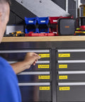 Worker using Portable Industrial Label Printer With Bluetooth And Pro Label Tool App Hands Free Belt Clip For Tight Jobsite Spaces