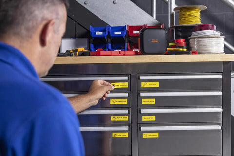 Worker using Portable Industrial Label Printer With Bluetooth And Pro Label Tool App Hands Free Belt Clip For Tight Jobsite Spaces