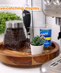 Slick 13 Inch Acacia Wood Lazy Susan Turntable Organizer For Kitchen Cabinets with coffee jar and plant on countertop.
