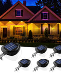 Solar Fence Lights Six Pack With 9 LED Warm White Outdoor Waterproof UFO Design shown illuminating a house exterior.
