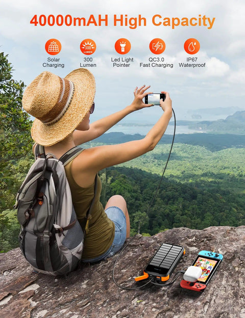 Person using Beast Solar Power Bank 40000mAh Portable Charger With PD 20W Fast Charging Built In 4 cables connected to devices outdoors