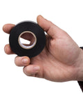 Electrical tape roll, black vinyl, 3/4 in x 60 ft, single roll, held in hand for scale
