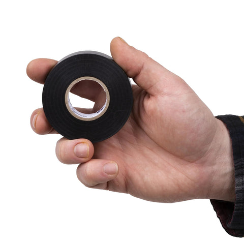 Electrical tape roll, black vinyl, 3/4 in x 60 ft, single roll, held in hand for scale