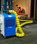 Heavy Duty Outdoor Portable Air Conditioner With 13700 Btu Cooling Capacity For Up To 315 Square Feet in use with duct kit in a warehouse.