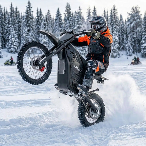 Rider performing a wheelie on Powerful 4000W Electric Dirt Bike For Teens And Adults with 45 MPH peak speed, snow background