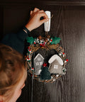 Person hanging a wreath on a door using Damage Free Adhesive Hooks Set With Sixteen Hooks And Thirty Two Strips Holds Up To Five Pounds Per Hook For Easy Install On Smooth Surfaces Great For Kitchen Bathroom Dorm And Renters Friendly Organization