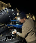 Man using Your Go To Rechargeable Tactical Headlamp With 230 Degree Wide Beam LED USB C Powered Motion Sensor for car repairs at night.