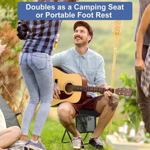 Man sitting on Ultralight Folding Camp Stool With Side Pocket And Carry Bag playing guitar outdoors, surrounded by friends