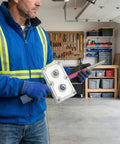 Person using Drill Powered Wire Puller And Automatic Cable Threading Machine Smooth Conduit Wizard in a garage.
