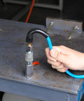 Person connecting Solid As Nails 1/4 Inch By 25 Foot Polyurethane Coil Air Hose With Instant Spring Back Rewind to a fitting.