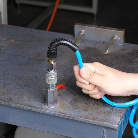 Person connecting Solid As Nails 1/4 Inch By 25 Foot Polyurethane Coil Air Hose With Instant Spring Back Rewind to a fitting.