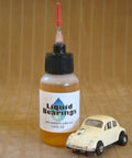 Bottle of 100 Percent Synthetic HO Slot Car Oil That Displaces Old Oils And Boosts Speed next to a small toy car