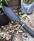 Heavy Duty Garden Spade Hand Shovel For Digging And Planting, A Multi Purpose Trowel With Steel Build And Rust Resistant Finish next to plant