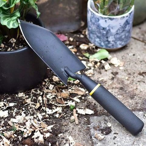 Heavy Duty Garden Spade Hand Shovel For Digging And Planting, A Multi Purpose Trowel With Steel Build And Rust Resistant Finish next to plant