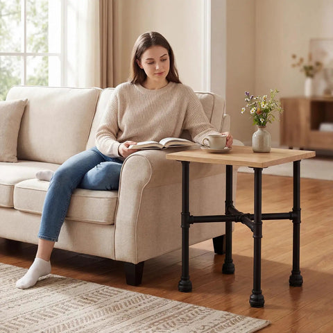 Woman using Industrial Pipe Table Legs Set Heavy Duty Metal X Shaped Base as side table next to sofa