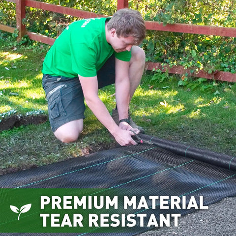 Person installing Heavy Duty Weed Barrier Fabric 3 Ft By 50 Ft Woven Landscape Ground Cover Mat for gardening