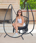 Woman relaxing on Ultimate Outdoor Hammock Swing With Stand For Your Patio Or Backyard, Hanging Chair With Removable Seat Cushion