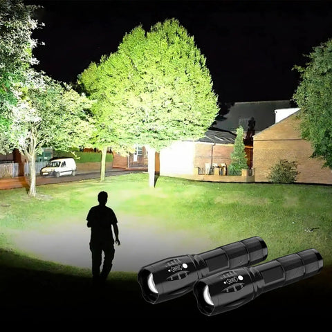Night outdoor scene lit by Beast Mode LED Flashlight Set, 2 Pack Small Tactical Lights with Zoomable Lens in active use.