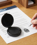 Straight Up Slick Mini Finger Print Ink Pads Set Of Two Quick Drying Black Stamp Supplies featuring a black ink pad on a contract.