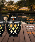 Waterproof Tiki Torch Bluetooth Speaker Two Pack Portable Party Speaker With Flickering LED Lights Perfect For Travel Backyard Parties Poolside And More on wooden deck