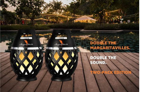 Waterproof Tiki Torch Bluetooth Speaker Two Pack Portable Party Speaker With Flickering LED Lights Perfect For Travel Backyard Parties Poolside And More on wooden deck