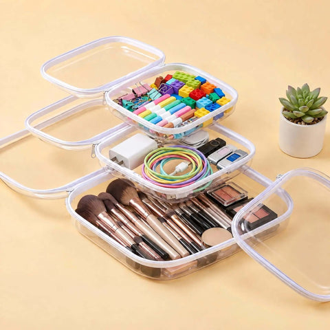 Game Changing Clear Hard Shell Zipper Pouches Including One Medium And Three Small Sizes Designed To Master Your Diaper Bag Setup While Keeping All Daily Essentials Secure And Hassle Free, shown stacked with various items.