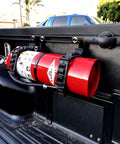 SINOKING rubber mounting clamp (2.5–7.5 in) secures red fire extinguisher to pickup bed wall.