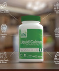 Liquid Calcium Magnesium Vitamin D Bone Boost With Boron And Six Calcium Sources Three Magnesium Forms Third Party Tested Non GMO Gluten Free Promotes Strong Bones And Healthy Joints Pack Of 100 bottle on a countertop.