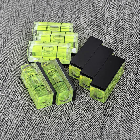 Top Tier 5 Piece Set Of Mini Magnetic Bubble Levels Your Go To Pocket Spirit Squares With Rock Strong Adhesion, five green bubble levels on fabric.