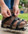 Person wearing Heavy Duty Lawn Aerator Shoes With Stainless Steel Nails, Adjustable Straps That Fit Any Shoes on a patio.